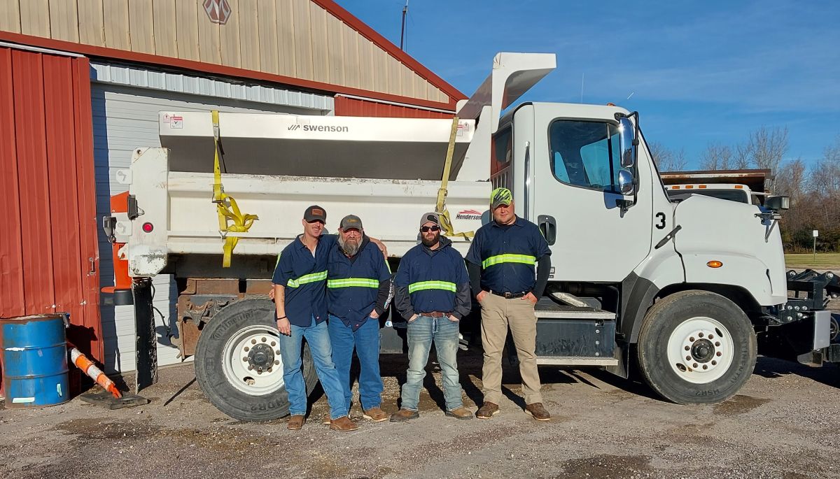 Street Department crew standing in front of dump truck